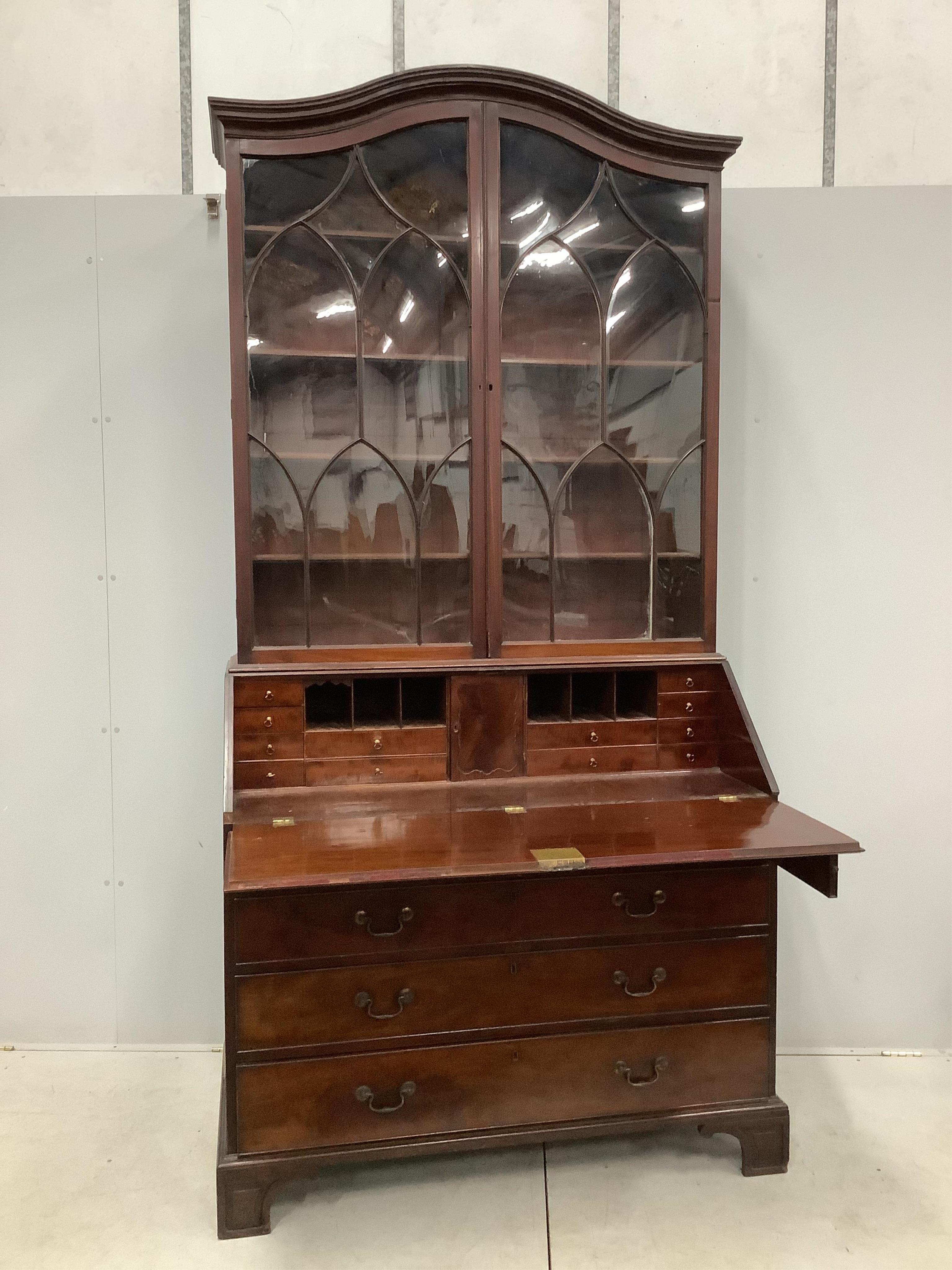 A George III mahogany bureau with associated domed top, width 122cm, depth 60cm, height 250cm. Condition - fair, two bracket feet in need of restoration but pieces present